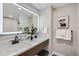 Elegant bathroom with a double vanity, marble countertops, and modern fixtures at 7076 S Newland St, Littleton, CO 80128