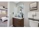 Modern bathroom with a floating vanity, illuminated mirror, and stylish fixtures at 7076 S Newland St, Littleton, CO 80128