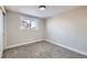 Simple bedroom with neutral walls, carpet flooring, and a window at 7076 S Newland St, Littleton, CO 80128