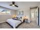 Comfortable bedroom with a ceiling fan and access to hallway bathroom at 7076 S Newland St, Littleton, CO 80128