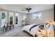 Spacious primary bedroom with large windows, ceiling fan, and plush carpeting at 7076 S Newland St, Littleton, CO 80128