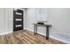 Light and airy entryway with hardwood floors and modern console table at 7076 S Newland St, Littleton, CO 80128
