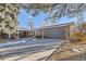 Ranch home with updated dark gray garage door and landscaping at 7076 S Newland St, Littleton, CO 80128