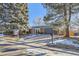 Updated brick ranch home with a dark gray garage door at 7076 S Newland St, Littleton, CO 80128