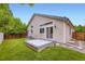 Landscaped backyard featuring a cozy patio, lush green grass, and mature trees for ultimate outdoor enjoyment at 2247 S Lima Ct, Aurora, CO 80014