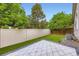 Green fenced backyard with a patio offering privacy and space for outdoor activities at 2247 S Lima Ct, Aurora, CO 80014