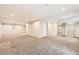 Spacious finished basement area with neutral carpeting, paint, and ample lighting for flexible living spaces at 2247 S Lima Ct, Aurora, CO 80014