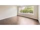 A spacious bedroom with gleaming hardwood floors, a large window, and freshly painted walls at 2247 S Lima Ct, Aurora, CO 80014