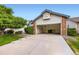 Inviting home exterior showcasing a well-maintained lawn, a spacious driveway and an attached two car garage at 2247 S Lima Ct, Aurora, CO 80014