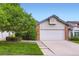 Charming home with a two-car garage, fresh lawn, mature tree, and lovely front yard landscaping at 2247 S Lima Ct, Aurora, CO 80014
