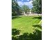 Expansive community greenspace with manicured lawn, mature trees, and a tranquil atmosphere at 2247 S Lima Ct, Aurora, CO 80014