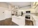 Modern kitchen boasts stainless appliances, white cabinets, mosaic backsplash, and hardwood floors at 2247 S Lima Ct, Aurora, CO 80014