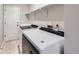 Modern laundry room equipped with appliances, and convenient storage shelving for efficient laundry tasks at 2247 S Lima Ct, Aurora, CO 80014