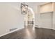 Living room with hardwood floors, gray walls, white trim and architectural features and modern lighting at 2247 S Lima Ct, Aurora, CO 80014