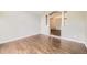 An open floor plan with light gray walls and gleaming hardwood floors throughout the living area at 2247 S Lima Ct, Aurora, CO 80014