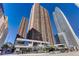 A view of a high-rise building complex on a sunny day with a row of businesses on the ground floor at 1020 15Th St # 17K, Denver, CO 80202