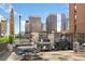 Rooftop patio area features a grill, dining table, seating, and a view of the city skyline at 1020 15Th St # 17K, Denver, CO 80202