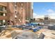 Relaxing outdoor patio offers lounge chairs, dining tables, and views of the city at 1020 15Th St # 17K, Denver, CO 80202