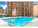 Bright blue swimming pool with lounge chairs on the pool deck at 1020 15Th St # 17K, Denver, CO 80202