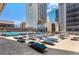 Rooftop pool deck with blue lounge chairs, tables, and city views perfect for relaxation at 1020 15Th St # 17K, Denver, CO 80202