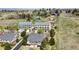 A bird's eye view of townhomes in a community with green lawns, a tennis court, and adjacent fields at 6701 W Yale Ave, Lakewood, CO 80227