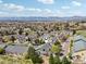 A residential area with townhomes, tree lined streets, and distant mountains, ideal for relaxed living at 6701 W Yale Ave, Lakewood, CO 80227
