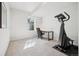 Basement featuring gym equipment, carpeted floor, and bright window for natural light at 6701 W Yale Ave, Lakewood, CO 80227