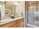 Bathroom features a double vanity with granite countertops and a tiled walk-in shower at 6701 W Yale Ave, Lakewood, CO 80227