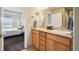 Bathroom with double sink vanity, granite countertops, and ample storage at 6701 W Yale Ave, Lakewood, CO 80227