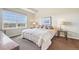 Cozy bedroom with a large window offering natural light and peaceful outdoor scenery at 6701 W Yale Ave, Lakewood, CO 80227