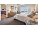 Inviting bedroom with abundant natural light and a well-appointed dresser and mirror at 6701 W Yale Ave, Lakewood, CO 80227