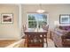 Inviting dining area with large window showcasing natural light and serene outdoor views at 6701 W Yale Ave, Lakewood, CO 80227