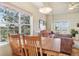 Bright dining area with natural light, complemented by the view of nature outside the window at 6701 W Yale Ave, Lakewood, CO 80227