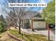 Charming home with a two-car garage, manicured lawn, and inviting brick-paved patio at 6701 W Yale Ave, Lakewood, CO 80227