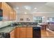Functional kitchen with granite countertops, cabinetry, and direct view into dining area at 6701 W Yale Ave, Lakewood, CO 80227