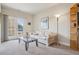 Cozy living room with a large window view to balcony, a decorative couch, and a bookcase at 6701 W Yale Ave, Lakewood, CO 80227