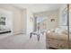 Bright living room with a glass coffee table and balcony doors to let the sunshine in at 6701 W Yale Ave, Lakewood, CO 80227