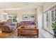 Bright and airy living room with hardwood floors, cozy seating, and natural light at 6701 W Yale Ave, Lakewood, CO 80227