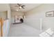 The carpeted loft includes a ceiling fan and built-in shelving and desk space at 6701 W Yale Ave, Lakewood, CO 80227