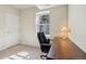 Office space with carpet, a large window for natural light, and standard desk at 6701 W Yale Ave, Lakewood, CO 80227