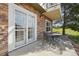 Patio with stone siding, an outdoor table, and a secure, decorative security gate at 6701 W Yale Ave, Lakewood, CO 80227