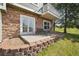 Patio featuring stone siding, an outdoor table, and a small retaining wall and lawn at 6701 W Yale Ave, Lakewood, CO 80227