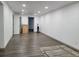 Unfinished basement with hardwood floors, white walls, and recessed lighting at 9133 W Cedar Dr # A, Lakewood, CO 80226