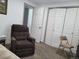 Bedroom with comfy armchair, closet, and a window for natural light at 9133 W Cedar Dr # A, Lakewood, CO 80226