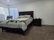 Bedroom with big windows, dark furnishings, soft carpet, and comfy bedding at 9133 W Cedar Dr # A, Lakewood, CO 80226