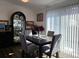 Cozy dining room with a dark wood table, grey chairs, and natural light streaming through the window blinds at 9133 W Cedar Dr # A, Lakewood, CO 80226