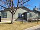 Inviting exterior of home with mature trees, well-maintained lawn, and visible 'For Sale' sign in the window at 9133 W Cedar Dr # A, Lakewood, CO 80226