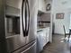 Modern kitchen with stainless steel refrigerator, white cabinets, and sleek countertops at 9133 W Cedar Dr # A, Lakewood, CO 80226