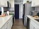 Well-lit kitchen with stainless steel appliances, white countertops, and gray backsplash at 9133 W Cedar Dr # A, Lakewood, CO 80226