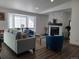 Bright living room featuring plush seating, a stone fireplace, and a large bay window for ample natural light at 9133 W Cedar Dr # A, Lakewood, CO 80226